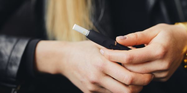 Hands holding an e-cigarette.