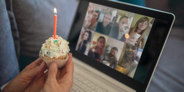 person holding cupcake while having a video conference call